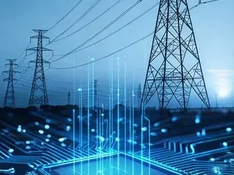 High-voltage transmission pylons and power lines against a blue sky.